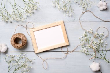 Vintage fotoğraf çerçevelemek açık mavi ahşap renkli çiçekleri ile. Afiş mockup womans ya da anne günü, düğün davetiyesi, Paskalya kartı ile kutlama için. Düz yatıyordu, en iyi görünüm, kopya alanı metin için.