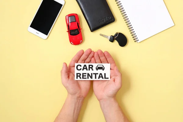 Car rental concept. Human hands holding text sign \