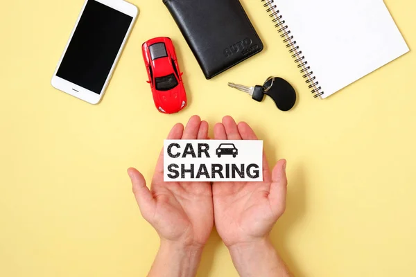 Car sharing concept. Human hands holding text sign \