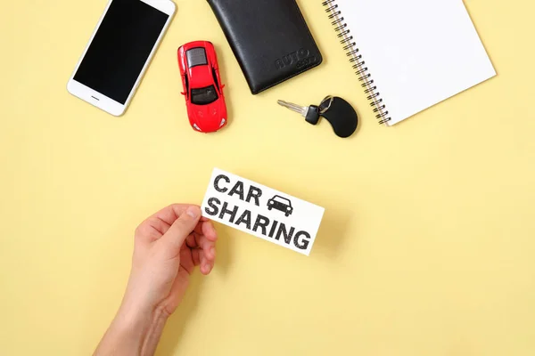 Car sharing concept. Human hand holding text sign \