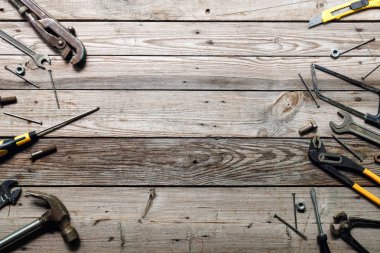 Kaba ahşap arka plan üzerinde vintage marangozluk araçları ile Düz yatıyordu kompozisyon. Marangoz farklı araçları ile üst görünüm tezgah. Ahşap işçiliği, işçilik ve el işi konsepti.