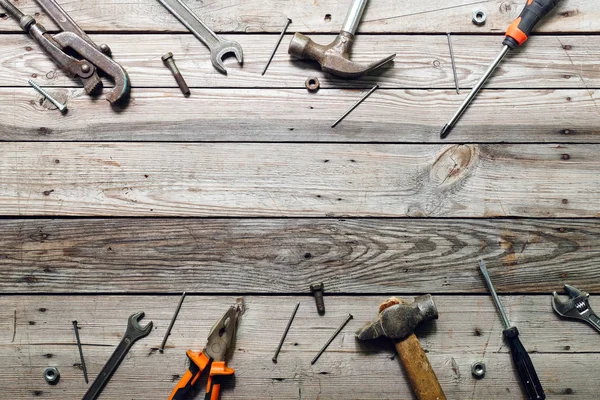 stock image Flat lay composition with vintage carpentry tools on rough wooden background. Top view workbench with carpenter different tools. Woodworking, craftsmanship and handwork concept.