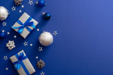 Noel gümüş hediye kutuları veya yay kurdele, baubles, süslemeleri, kopya alanı ile sihirli koyu mavi arka plan konfeti ile hediyeler. Vintage Xmas tebrik kartı mockup, kartpostal şablonu. Düz yatıyordu