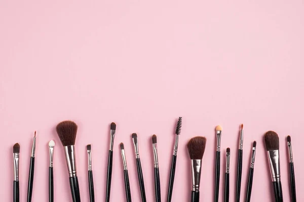 Set Makeup Brushes Row Pink Background Flat Lay Top View — Stock Photo, Image