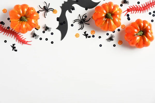Halloween party decorations frame border on white background. Flat lay, top view. Happy halloween holiday concept.