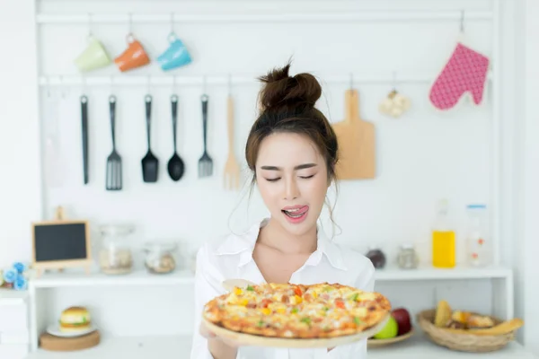 Mujer disfrutando de la pizza en su habitación — Foto de Stock