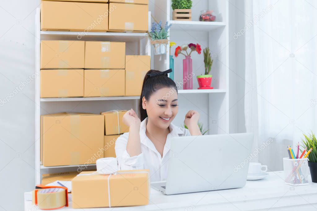 business owner working at home office packaging on background