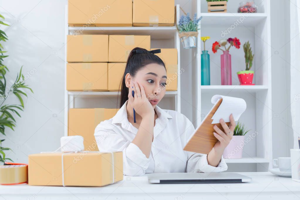 business owner working at home office packaging on background