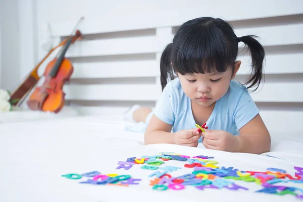 Mother and daughter studying the alphabet — Stock Photo, Image