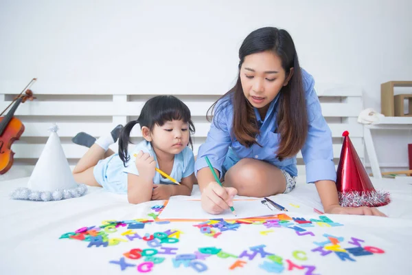 Mother and daughter studying the alphabet — Stock Photo, Image