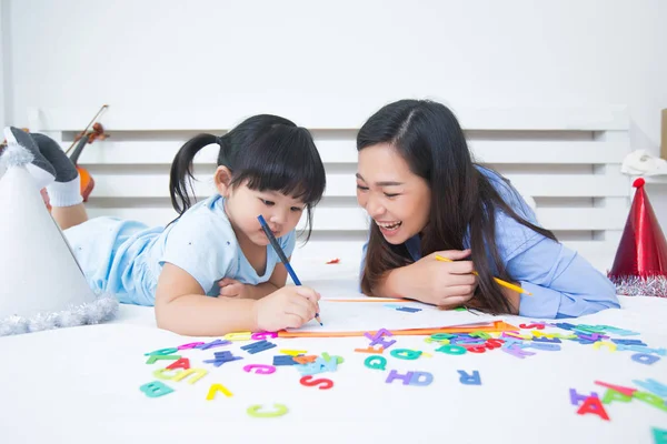 Mother and daughter studying the alphabet — Stock Photo, Image