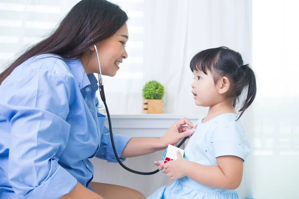 Mother and daughter playing doctor with stethoscope