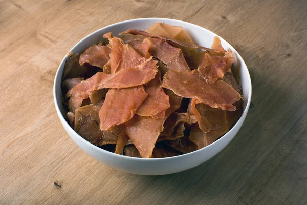 snack for beer and wine, jerky meat chips, in a plate