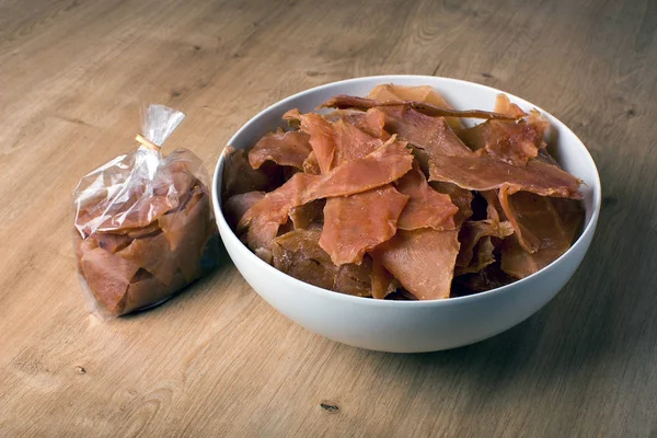 snack for beer and wine, jerky meat chips, in a plate