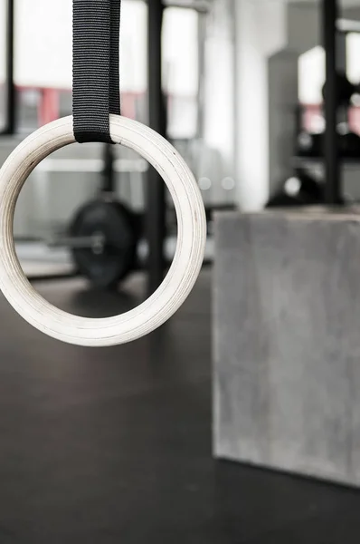 Closeup of gymnastics ring, box and crossfit gym interior in background