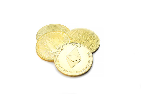 Closeup of one golden Ethereum and three Bitcoin coins isolated on white