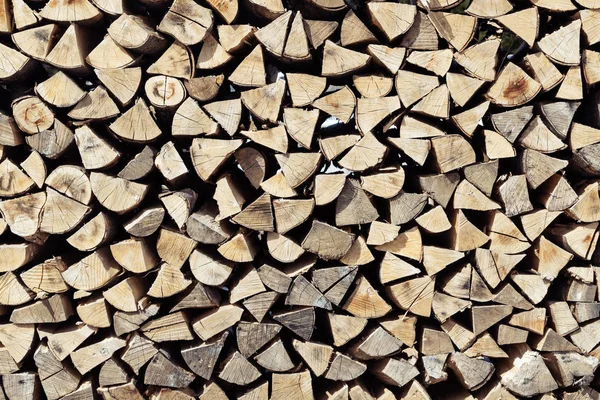 Pile of neatly stacked cut and split spruce tree firewood viewed from front — Stock Photo, Image