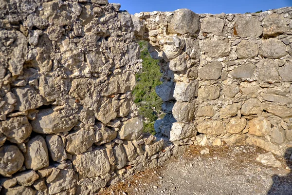 The hole in the wall of the castle Monolithos