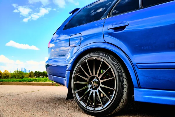 Aggressive sport car in blue against the background of nature — Stock Photo, Image