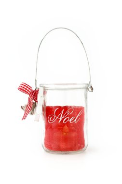 Homemade, DIY, Glass Jar Christmas Tealight candle holder with handle and Noel writing, jingle bells, red ribbon, white wooden star and bow. Lit Tealight inside.  clipart
