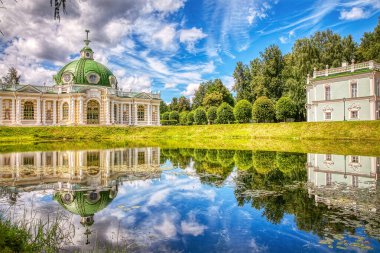 Güneşli bir yaz gününde Kuskovo Park 'ta güzel bir yansıması olan Grotto köşkü ve İtalyan evi, XVIII. Yüzyılın mimari ve sanatsal topluluğu. MOSCOW-Haziran 2020