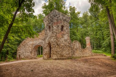 Yazın Tsaritsyno malikanesi. Moskova 'daki Tsaritsyno Parkı' ndaki kulenin kalıntıları bulutlu bir yaz gününde yeşil ağaçların arasında. Moskova-Temmuz 2020