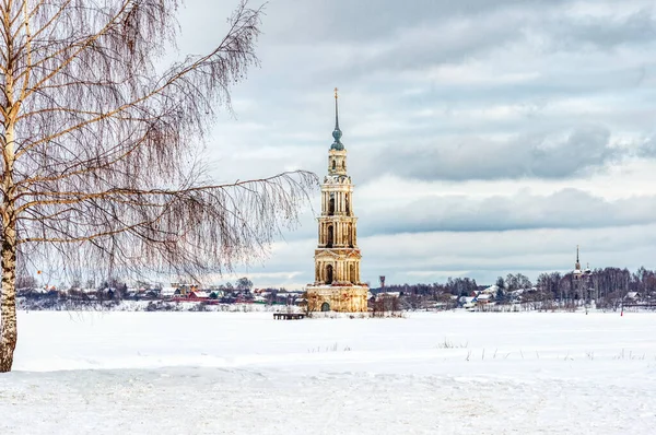 Ancient bell tower of the flooded Church on the Volga in Kalyazin. Winter landscape with a flooded bell tower on the ice-covered Volga.