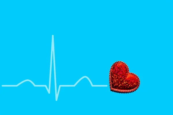 The image of the heart rate of a red heart on a blue background is isolated. The concept of a healthy lifestyle