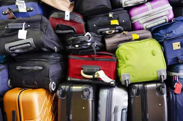 Suitcases multicolor stacked for transport one above the other — Stock Photo, Image