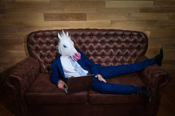 Strange man in suit working at home office. Unusual young manager