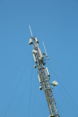 Arka planda mavi gökyüzüne sahip iletişim kulesi