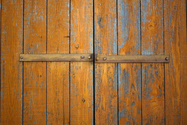 Old wooden orange doors to the garage