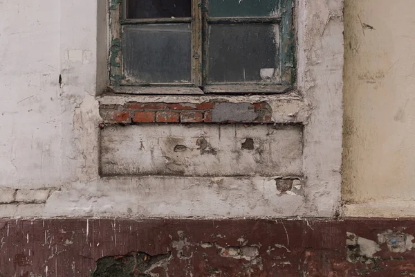 Old destroyed brick wall. Wooden window with dirty glass. Background Texture