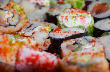 Japon suşi yiyeceği. Ton balığı, somon, karides, yengeç ve avokado ile rulo. 