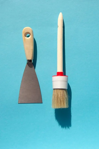 Tool for painting work. Spatula and brushes. Set of items for repair. Top view of a builder with a brush and spatula