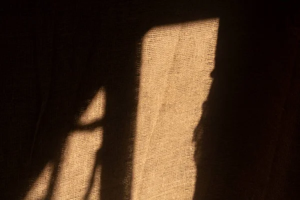 sunlight and shadow on a background of linen.