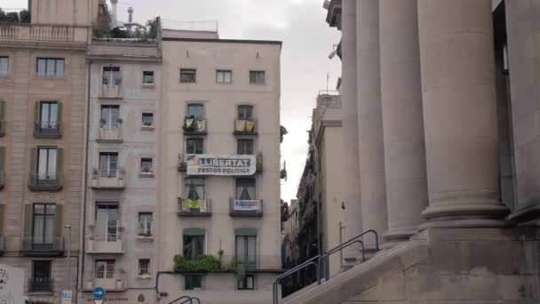 Barcelona, Hiszpania - lutego 2019. Dzielnicy w Barcelonie z balkonem, na którym są zawieszone flagi Katalonii i żółty plakat wstążki i protest. Pojęcie separatyzm i oderwania się od — Wideo stockowe