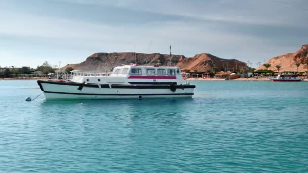 Sharm El Sheikh, Egypte-december, 2018: twee identieke retro boten afgemeerd in de turquoise wateren van de zee in de buurt van de kust. Slow Motion — Stockvideo
