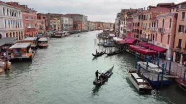 Venedik, İtalya - Mayıs 2019: Venedik'te Akşam. Yorgun gondolcular gondol. Rialto Köprüsü'nden Büyük Kanal manzarası. Yavaş çekim