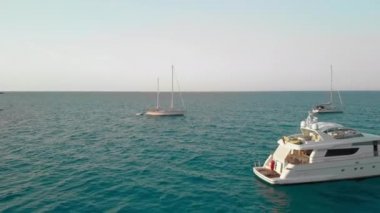 Okyanusta bir yelkenli yat tekneromantik gün batımı. Turkuaz berrak su ve lüks rahatlama. Havadan insansız hava aracı vuruldu