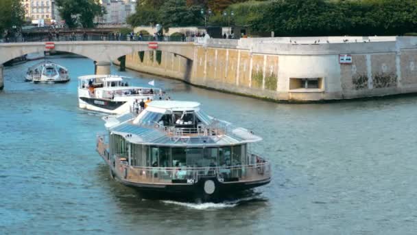Paryż, Francja - wrzesień 2019: Paryż, Francja - wrzesień 2019: statek wycieczkowy płynie wzdłuż Sekwany niedaleko Notre-Dame de Paris. — Wideo stockowe