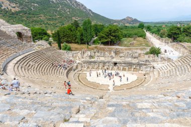 Efes, Türkiye - 20 Haziran 2018: Izmir, Türkiye'de bulutlu gökyüzü üzerinde tarihsel Ephesus şehir harabeye Antik Amfitiyatro.