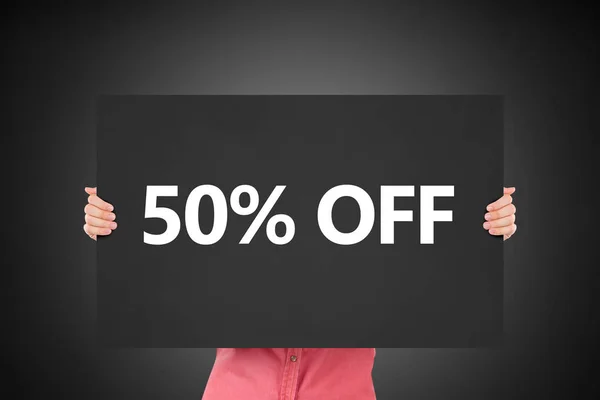 Hand Holding 50 Percent Discount on Black Board