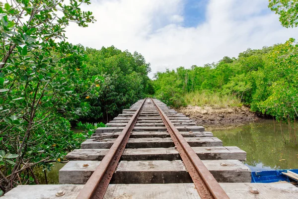 Bridge railway crossing with a moored dinghy