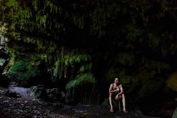 Man exploring natural cave systems in Fiji