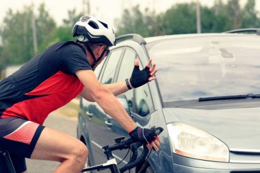 Forcing the right of way on the road for the driver of a car with the participation of a cyclist clipart