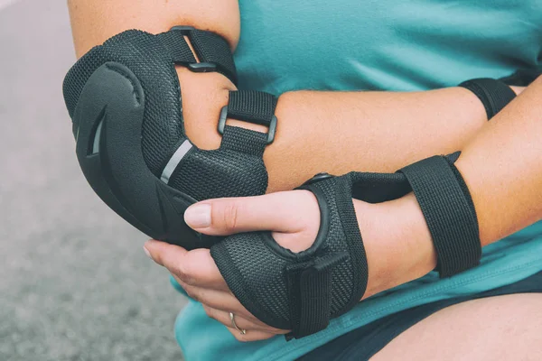 Kvinnlig Rullskridskoåkare Med Armbågsskydd Kuddar Handen Och Bär Handledsskydd — Stockfoto
