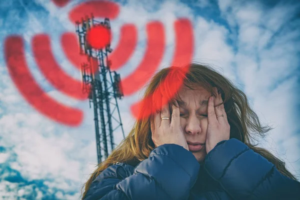 Woman is holding her head near the 5G BTS — Stock Photo, Image