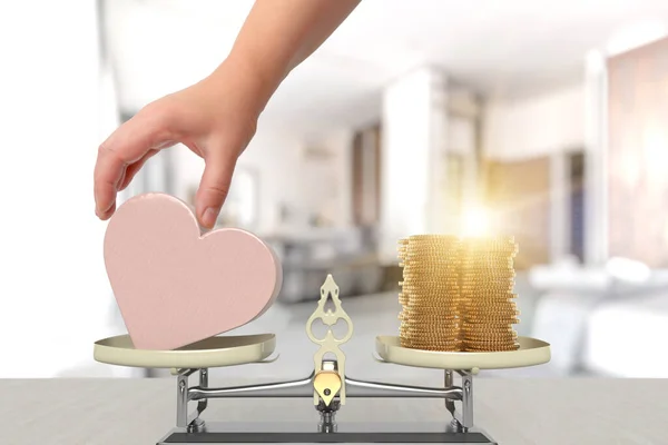 Balance scale with heart and money on two sides. The concept of expensive treatment, heart problems or, for example, relationship or marriage decisions