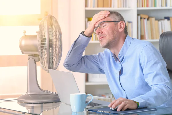 Hombre Sufre Calor Mientras Trabaja Oficina Trata Refrescarse Por Ventilador — Foto de Stock